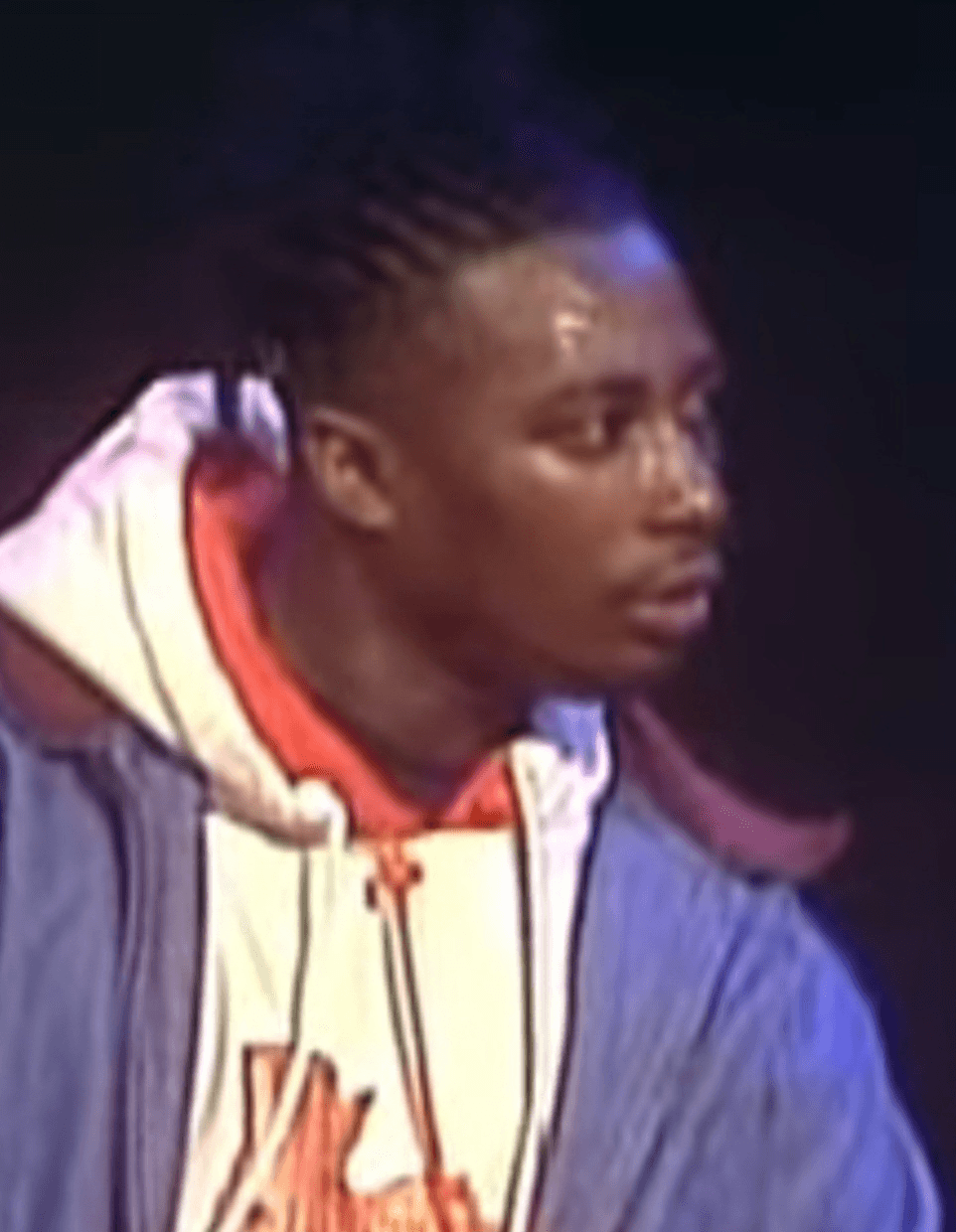 A blurry video still shows Ol' Dirty Bastard in profile, wearing a hooded jacket, looking off to the side against a dark background.