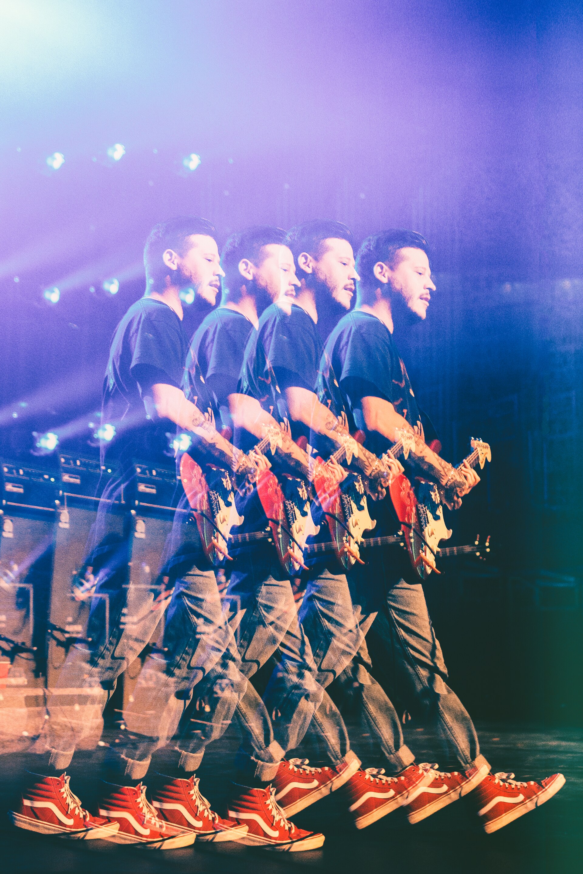 A multiple-exposure photograph repeats the Wavves frontman four times across the frame as he plays a red electric guitar in a dark T-shirt, jeans and red high-top trainers.