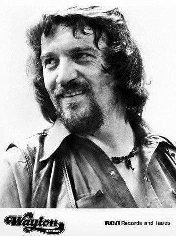 A black-and-white publicity portrait of Waylon Jennings smiling, with the Waylon Jennings and RCA Records and Tapes logos at the bottom.